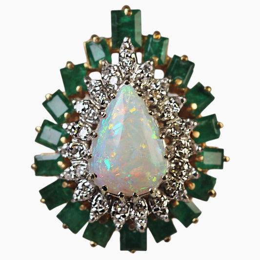 14Kt Gold Ring Set w. One Large Pear Shaped Opal Surrounded by 38 Round Brilliant Cut Diamonds & 18 Emerald Cut Emeralds